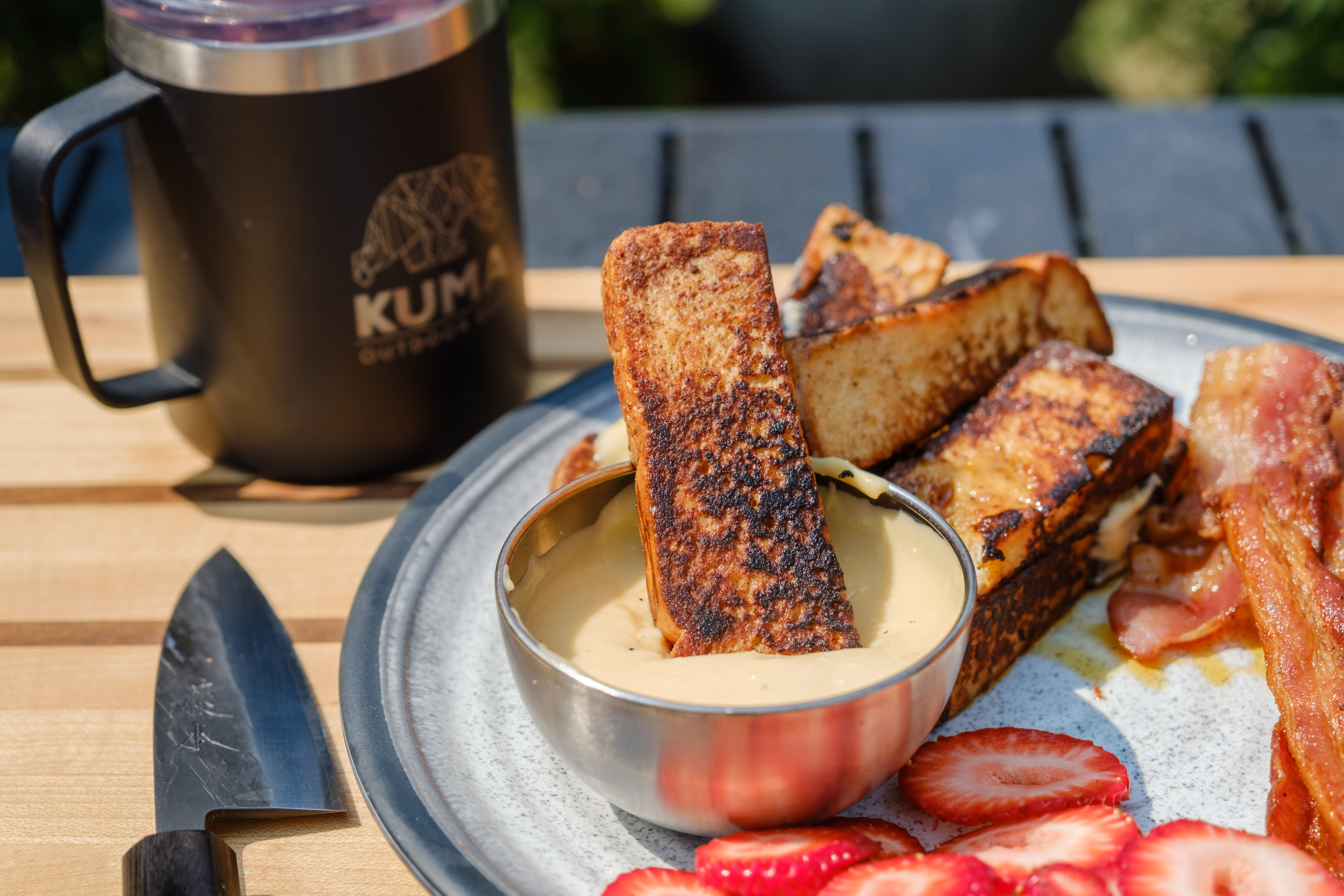 French Toast Sticks being dipped in Maple Cream Cheese Sauce